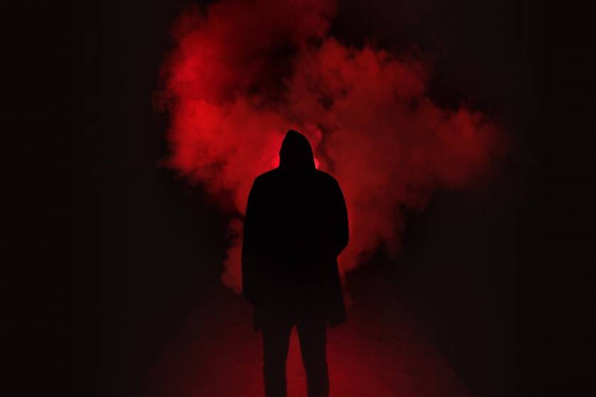 silhouette of person on a dark place with smoke